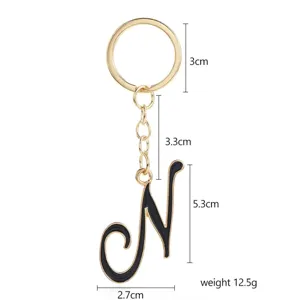 Gold and black letter N keychain metal bag charm with detailed size measurements and weight info