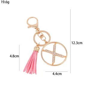 Detailed size view of metal rhinestone letter pink tassel keychain and bag charm pendant.