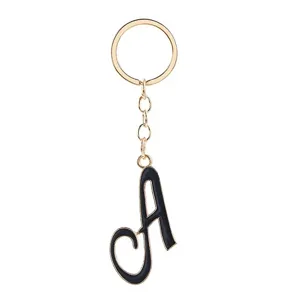 Gold tone metal keychain with black enamel letter A pendant, stylish bag charm and key ring.