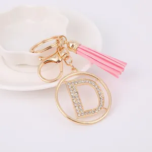 Rhinestone letter D metal keychain with pink tassel charm for bags and keys detail view.