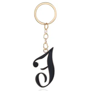 Gold metal keychain with stylish black letter pendant for women bags and keys daily use.