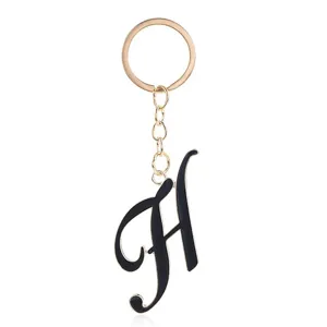 Elegant black enamel letter H keychain with gold tone ring and chain pendant accessory.