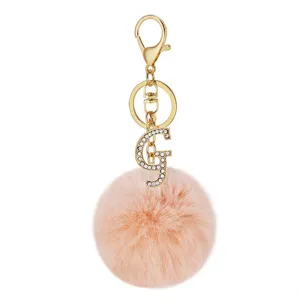 Detailed view of the pink fluffy pom pom keychain with sparkling rhinestone letter G charm.
