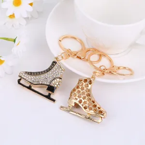 Exquisite metal ice skate keychain detail featuring sparkling rhinestones and hollow flower charm.