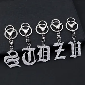 Detail shot of silver rhinestone gothic letter keychain metal pendant backpack charm.