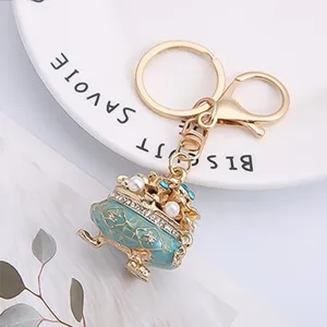 Chinese style treasure basin keychain with sparkling rhinestones and metal lucky pendant.
