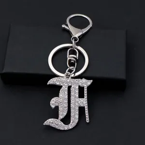 Detailed close-up shot of a silver rhinestone gothic alphabet letter keychain pendant.