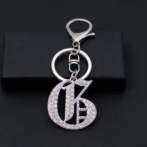 Detailed view of silver rhinestone letter keychain with lobster clasp, luxury accessory.