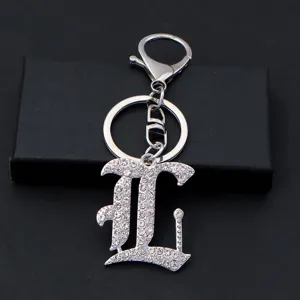 Detailed view of the silver metal rhinestone letter keychain, glittering diamond letter pendant charm.