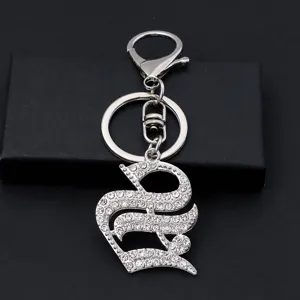 Silver rhinestone gothic letter keychain detail showing sparkling crystal metallic pendant hardware.