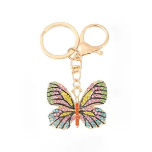 Gold-tone metal rhinestone butterfly keychain cute sparkling bag charm pendant gift accessory.