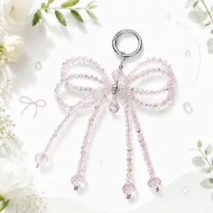 Crystal beaded bow keychain and bag charm with sparkling pink stones and silver ring.