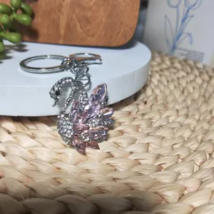Rinestone swan keychain detailed view, sparkling crystal alloy bag pendant and car key accessory.