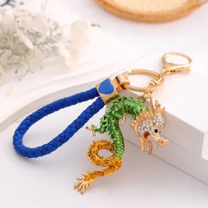 Detailed view of the Chinese zodiac dragon keychain with rhinestone embellishment and blue rope.
