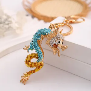 Exquisite Chinese zodiac dragon rhinestone metal keychain car bag pendant fine detail view.