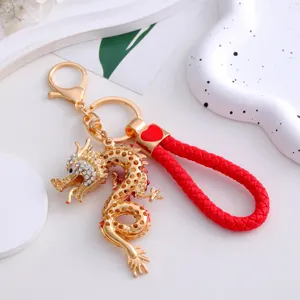 Chinese style dragon keychain with red braided leather strap and sparkling rhinestones.