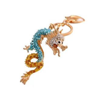Exquisite rhinestone dragon keychain detailed close-up, luxury metal zodiac pendant charm.