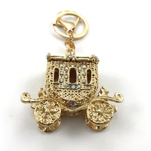 Exquisite gold alloy pumpkin carriage keychain with sparkling rhinestones, detailed craftsmanship.