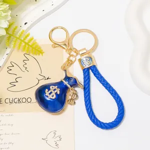 Porte-clés sac d'argent bleu avec lanière en cuir strass dollar détail anneau en métal.