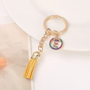 Gold alloy keychain with letter E charm and yellow tassel, stylish bag accessory gift.