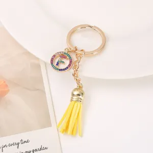 Gold metal tassel keychain with colorful rhinestone letter F charm for bag decoration.