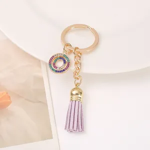 Chic rhinestone circle keychain with purple leather tassel, elegant gold metal key ring.