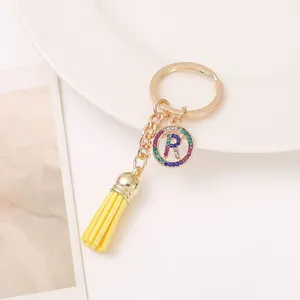 Gold metal letter R keychain with colorful rhinestones and yellow tassel bag accessory pendant.