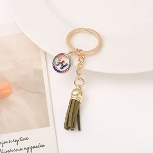 Close-up detail view of the elegant rhinestone letter tassel keychain and metal ring.