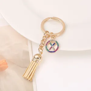 Elegant gold-tone rhinestone letter X tassel keychain stylish bag charm accessory for daily use.