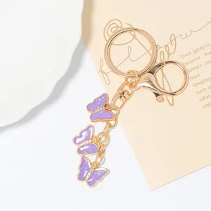 Light luxury creative butterfly keychain with rhinestones and metal rings, ideal birthday gift.