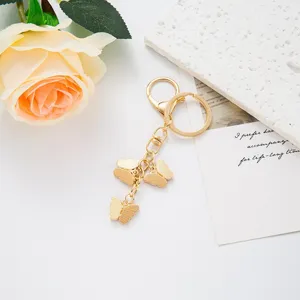 Gold butterfly keychain with multiple cute pendants, stylish metal keyring for women gifts.