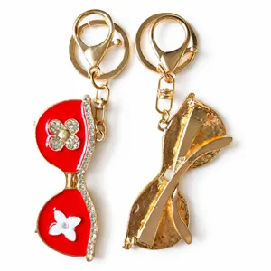 Luxury sunglasses keychain with sparkling rhinestones and clover flower design pendant for bags.