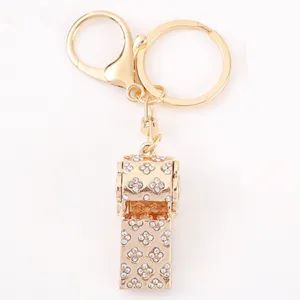 Gold rhinestone whistle keychain with clover crystal pattern, chic metal bag charm and key ring.