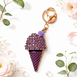 Close-up detail of the purple rhinestone ice cream keychain with gold clasp and flower decor.