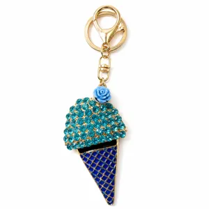 Close up view of the blue rhinestone ice cream keychain featuring a cute blue rose and gold hardware.