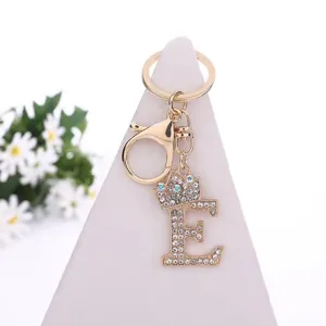 Detailed view of the sparkling rhinestone alloy letter E keychain with a cute crown charm.