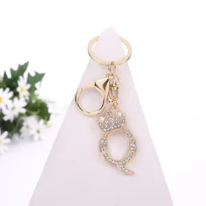 Gold rhinestone letter Q keychain with crown pendant, stylish bag charm and fashion accessory.