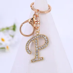 Rhinestone letter P keychain detail closeup, glittering alloy pendant for bags and keys.