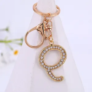 Gold alloy rhinestone letter Q keychain detail view, sparkling crystal pendant charm accessories.