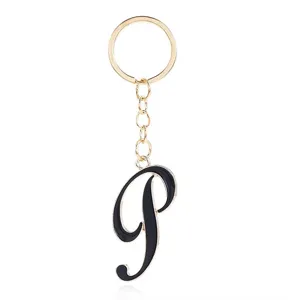 Detail view of a gold-tone keychain featuring a stylish black enamel letter P pendant charm.