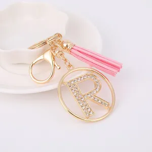 Gold metal rhinestone letter R keychain with pink tassel, stylish bag charm pendant for gifts.