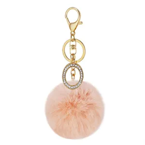 Fluffy faux rabbit fur pom pom keychain with rhinestone oval charm and gold hardware bag pendant.