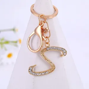 Close-up shot of a stylish gold alloy rhinestone letter S keychain pendant detail view.