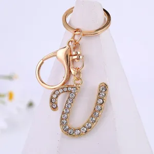Detailed shot of gold alloy rhinestone letter keychain pendant, elegant sparkly accessory.