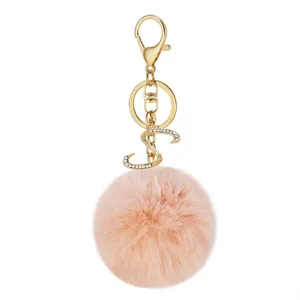 Fluffy faux rabbit fur pom pom keychain with rhinestone letter S gold bag charm accessory.