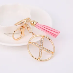 Detailed close-up of the stylish metal rhinestone letter keychain with a pink tassel.
