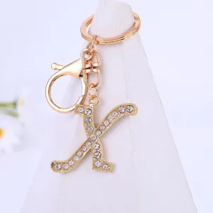 Close-up detail of the gold rhinestone letter K keychain pendant with lobster clasp and ring.