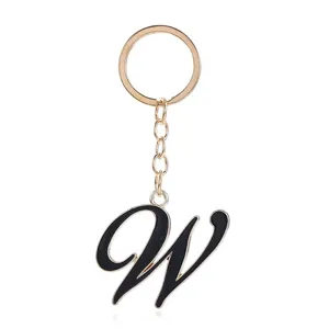 Golden metal keychain with black enamel letter W pendant, stylish bag charm accessory.