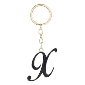 Gold metal keychain with black enamel letter charm for women bags and stylish accessories.