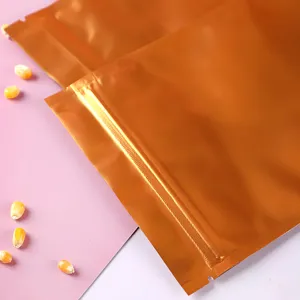Detailansicht goldener Aluminiumfolien-Standbeutel mit Druckverschluss und Maiskörnern